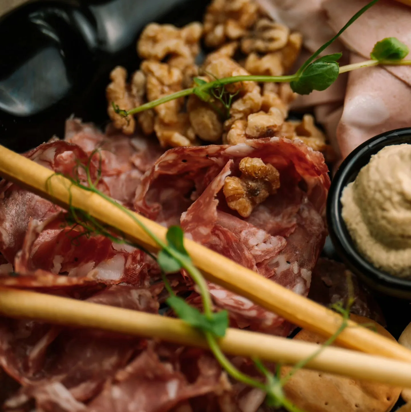 A board of cured meats, flatbread and accompaniments