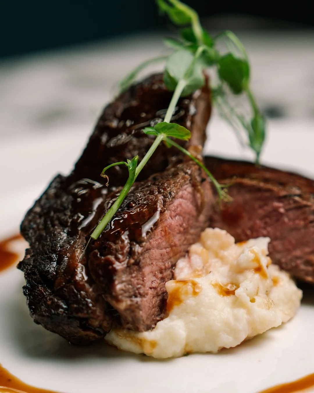 Seared steak with mashed potato and fresh greens
